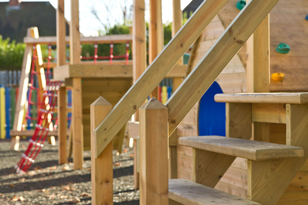 Playground apparatus with wooden steps and swings