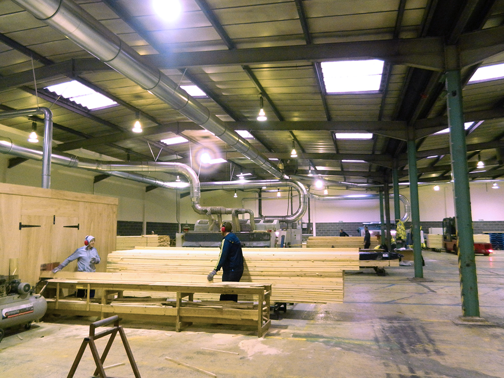 Wideshot of the workshop showing workers doing different jobs