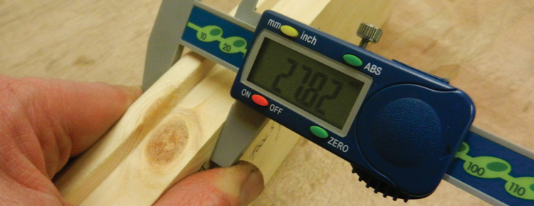 Precise measuring tool being used on planed timbers